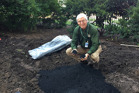 Gary Gilmore with biochar at the Governor's Residence raingarden