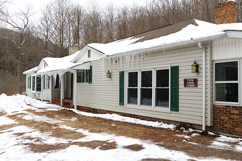 A house is covered in snow and icicles at Blue Knob State Park.
