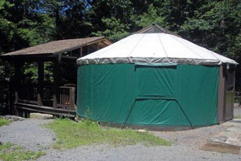 A round tent has a covered porch at Clear Creek State Park.