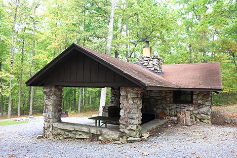 A stone cabin is in the forest at Cowans Gap State Park.