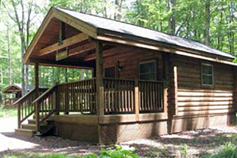 A modern log cabin is near trees at Hickory Run State Park.