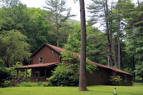 A modern cabin is by forest at Hyner Run State Park.