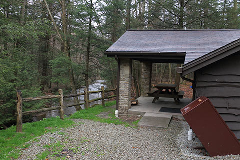 A rustic cabin overlooks a creek at Kooser State Park.