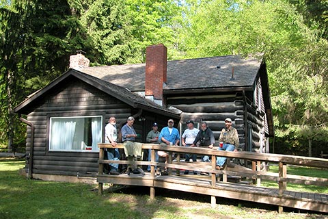 People enjoy a log cabin at Ole Bull State Park.