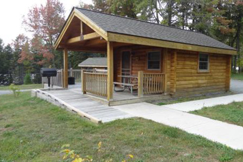 A cozy modern cabin has cement sidewalks at Promised Land State Park.