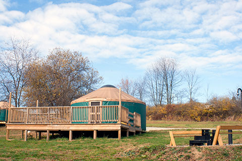 A round tent, a yurt, is on a platform with a nice wooden deck at Yellow Creek State Park.