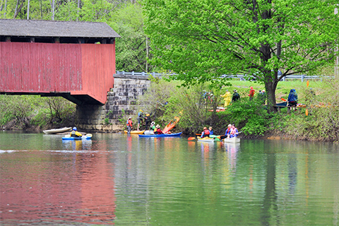 Outdoors, nature, river, water, people, boats, kayaks, covered bridge, trees