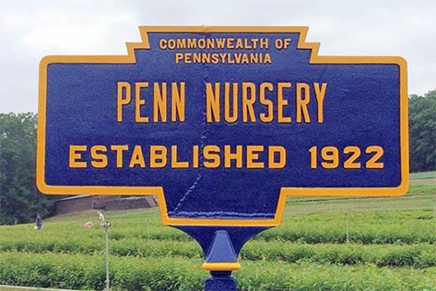 A wooden sign outdoors. Sign text: Penn Nursery Established 1922