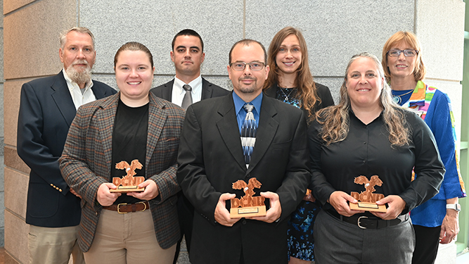 Gifford Pinchot State Park rangers pose in group photo holding wooden awards with DCNR staff